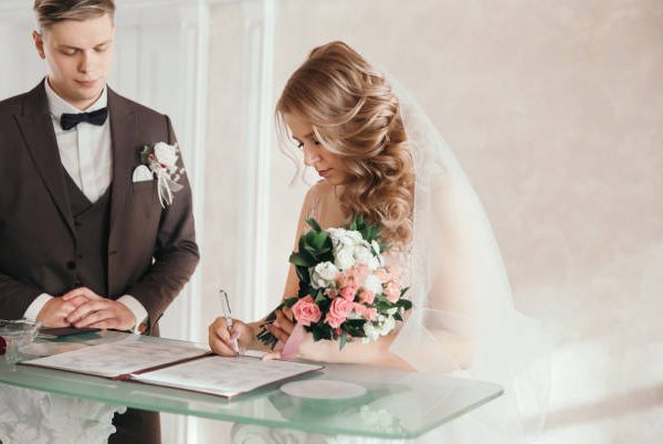 bride and groom signing the marriage contract. holidays and events